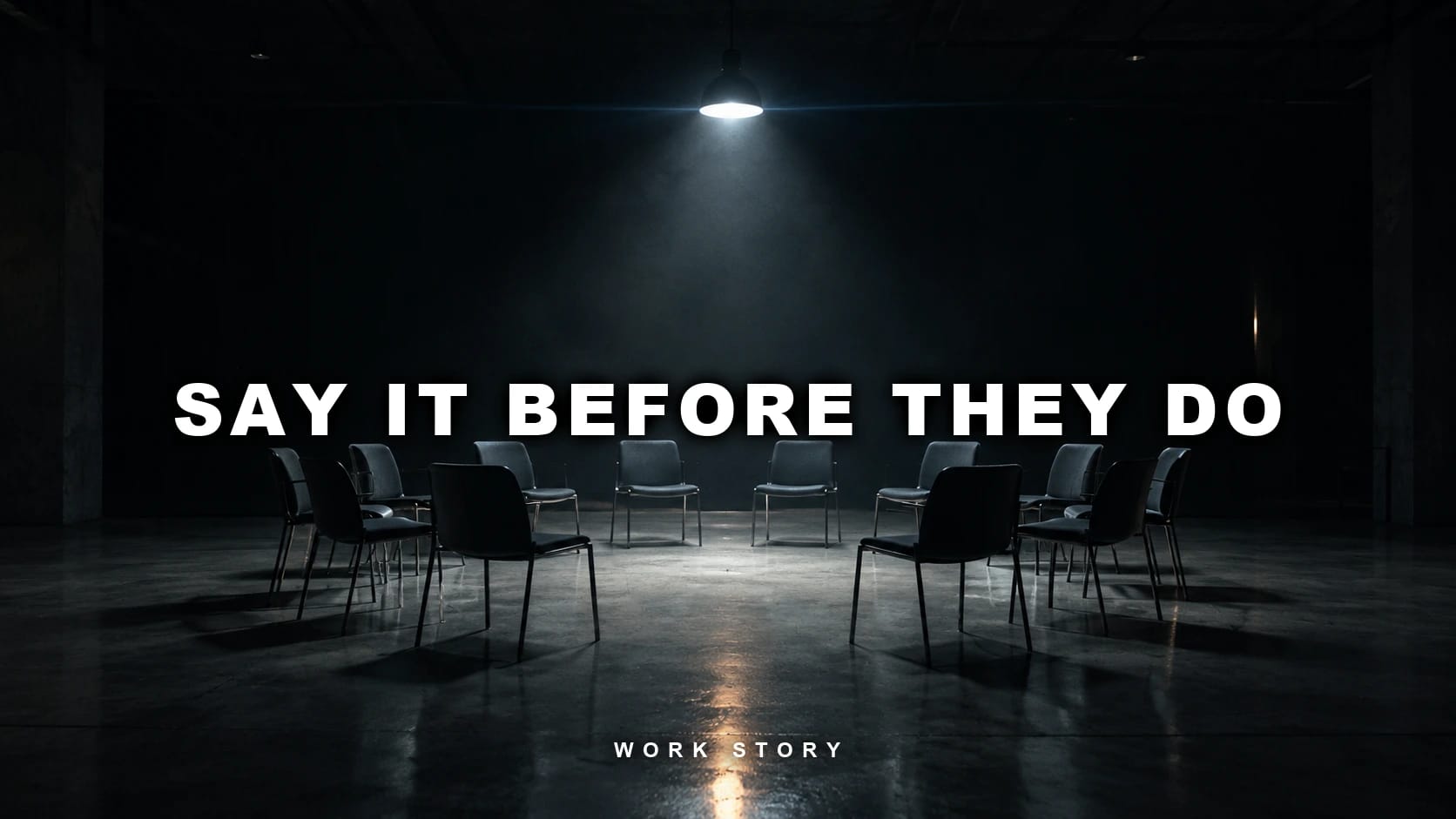 An empty circle of chairs under a single overhead light in a dark room, captioned "Say it before they do"